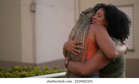 Female friend consoling desperate young woman. Two black sisters supporting each other. Friends embrace in crisis - Powered by Shutterstock