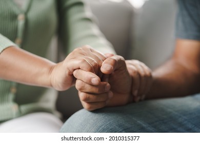 Female friend or family sitting and hold hands during cheer up to mental depress man, Psychologist provides mental aid to patient. PTSD Mental health concept - Shutterstock ID 2010315377