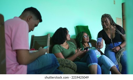 Female Friend Sharing Cellphone Screen To Group Of Girlfriends At Home. Candid Group Of Hispanic Black Friends Together