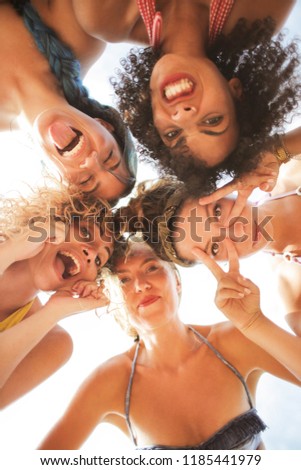 Similar – Young people with their heads together having fun