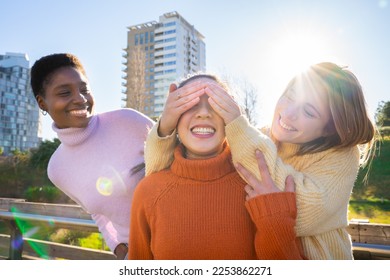 Female friends covering each other eyes for a surprise. Girls having fun together laughing. Reunion concept. High quality photo - Shutterstock ID 2253862271