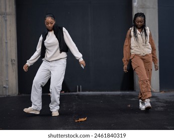 Female friends dancing to hip hop outdoors - Powered by Shutterstock