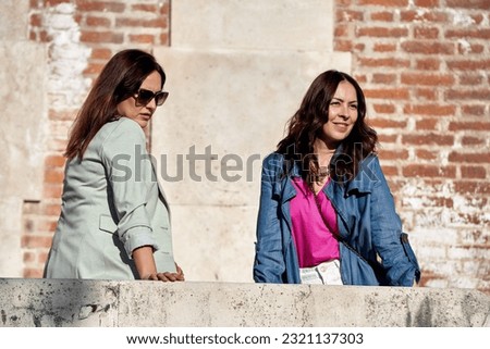 Similar – Image, Stock Photo Twin sisters laughing at a postcard in Erfurt