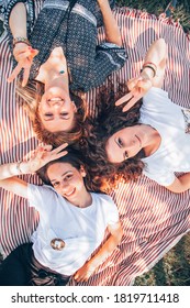 Female Friends Enjoying A Picnic In Nature.