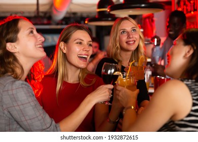 Female Friends Enjoying Wine In Night Club. High Quality Photo