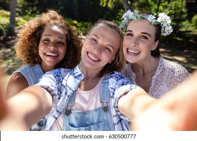 Female friends having fun in park on a sunny day - Shutterstock ID 630500777
