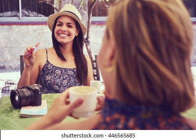 Female Friends On Holidays, Young Happy Women Sitting At Bar Smoking Electronic Cigarette. 