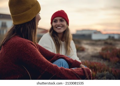 Female Friends Sitting Outside Having A Chat