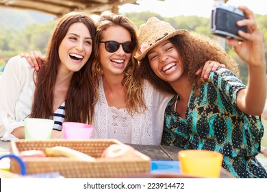 Female Friends Taking Selfie During Lunch Outdoors - Powered by Shutterstock