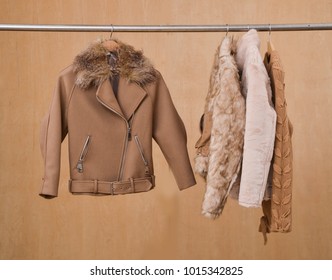 Female Fur Jacket ,coat Clothes On Hanger –wooden Background
