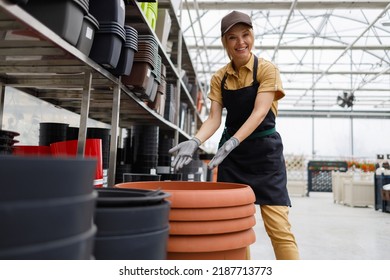 Female Garden Center Worker In Plants Pot Department