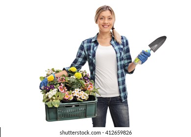 Female gardener holding a rack of flowers and a spade isolated on white background - Powered by Shutterstock