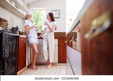 Female Gay Couple At Home In Kitchen Making Fresh Coffee