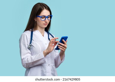 Female General Practitioner Medical Employee Reviewing Lab Results Using Smartphone, Medical App, Technical Progress. Intern Doctor Checking Patient Medical History In Electronic Clinical Record