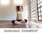 Female girl Attractive young asian woman doing stretching exercise on mat yoga Calmness and relax at gym Full body concentrated flexibility during workout.