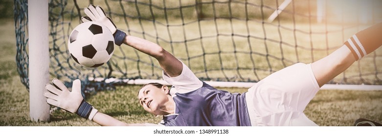 Female goalkeeper saving a goal during a game - Powered by Shutterstock