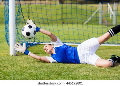 Female goalkeeper saving a goal during a game - Powered by Shutterstock