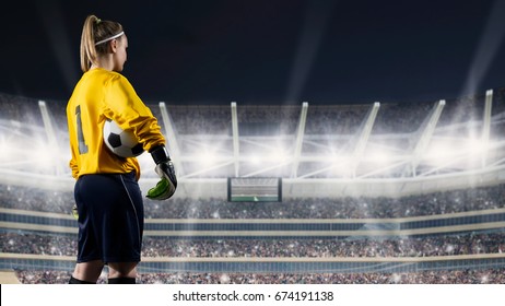 female goalkeeper standing with the ball against the crowded stadium at night - Powered by Shutterstock