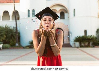 Female Graduate Blowing Confetti From Hands