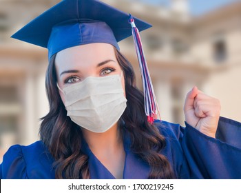 Female Graduate In Cap And Gown Wearing Medical Face Mask.