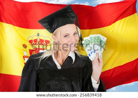 Female Graduate Student Holding Money In Front Of Spanish Flag