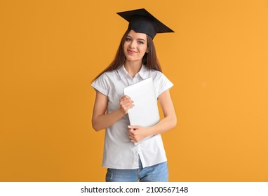 Female Graduating Student With Laptop On Color Background