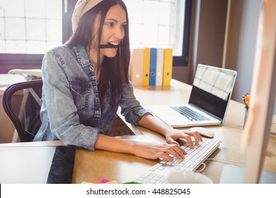 Female Graphic Designer Working On Computer At Office