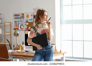 Female graphic designer working with tablet in office - Powered by Shutterstock
