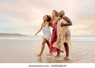 female group of three young women cooling off together on the seashore during a summer day. Friendship and unity - Powered by Shutterstock