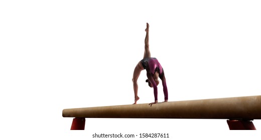 
Female gymnast doing a complicated trick on gymnastics balance beam isolated on white.
