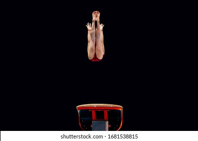 Female Gymnast Exercise Gymnastics Vault In Black Background