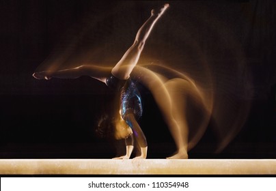 Female Gymnast In Motion On Balance Beam