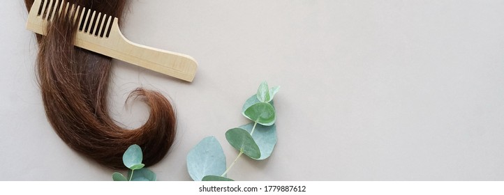 female hair,  bamboo comb, eucalyptus leaves on beige background banner top view, flat lay. copy space. Self care, hair treatment  concept. - Shutterstock ID 1779887612