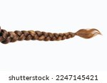 Female hair in the form of a braid on a white isolated background. Red hair braided close-up. Beautiful healthy natural female hair without dyeing