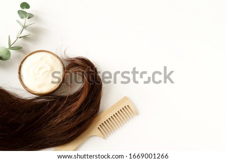 female hair, hair mask and bamboo comb on white background top view, flat lay. copy space. Self care, hair treatment  concept.