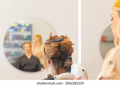 Female Hairdresser Working With Client In Salon, View From Behind, Hair Drying And Styling, View From Behind