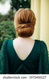 A Female Hairstyle Is A Low Bun On A Red-haired Girl Back View