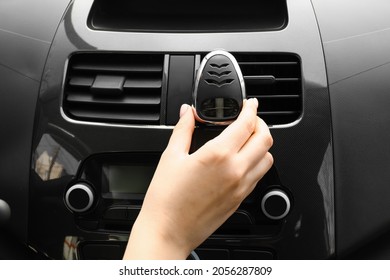 Female Hand With Air Freshener Hanging In Car, Closeup