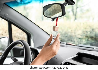 Female Hand With Air Freshener Hanging In Car