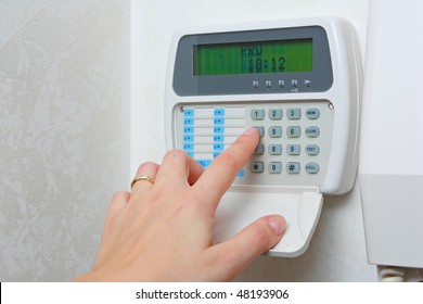 Female Hand Arming A Burglar Alarm System