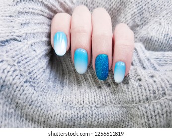 female hand beautiful manicure  sweater
