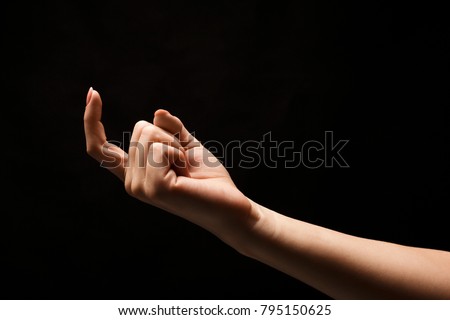 Female hand beckoning with forefinger, isolated on black background. Woman gesturing with one finger, calling up, come here symbol Stock photo © 