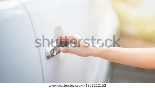 Female hand of a business\
woman with a pushing open botton of the car door. It’s selective\
focus.\
\
