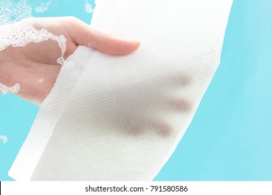 Female Hand Cleaning Window With Detergent And Paper Towel. Soap Stains On The Glass. Home Cleaning Concept.