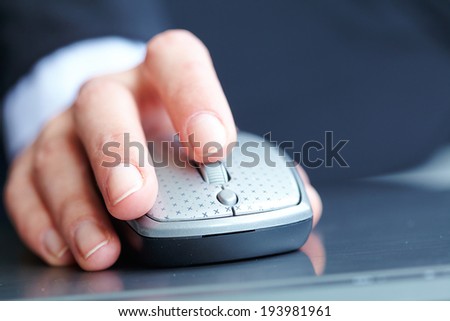 female hand clicking computer mouse