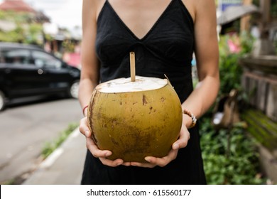 Female Hand With A Coconut And Bamboo Straw