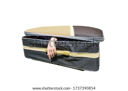 Female hand coming out of a suitcase. Imitation of the murder of a woman by a maniac or serial killer.