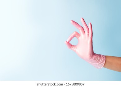 Female Hand In Cosmetology Medicine Pink Glove Pointing Up Okay, Yes, Accepting Hand Sign To The Side, Studio Shot, Copy Space Banner For Your Flyer Site Everything Will Be Fine Pandemic Coronavirus