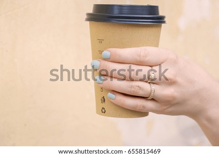 Female hand with cup and beautiful jewelry
