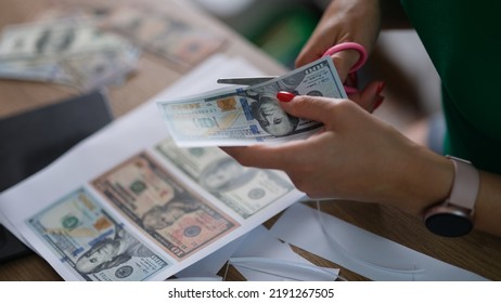 Female Hand Cuts Counterfeit Money American Dollars